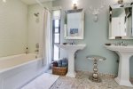 Newly Renovated Bathroom with dual pedestal sinks
